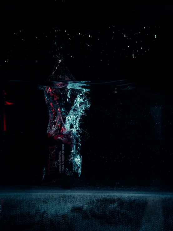 water drops from a red clock tower in the dark