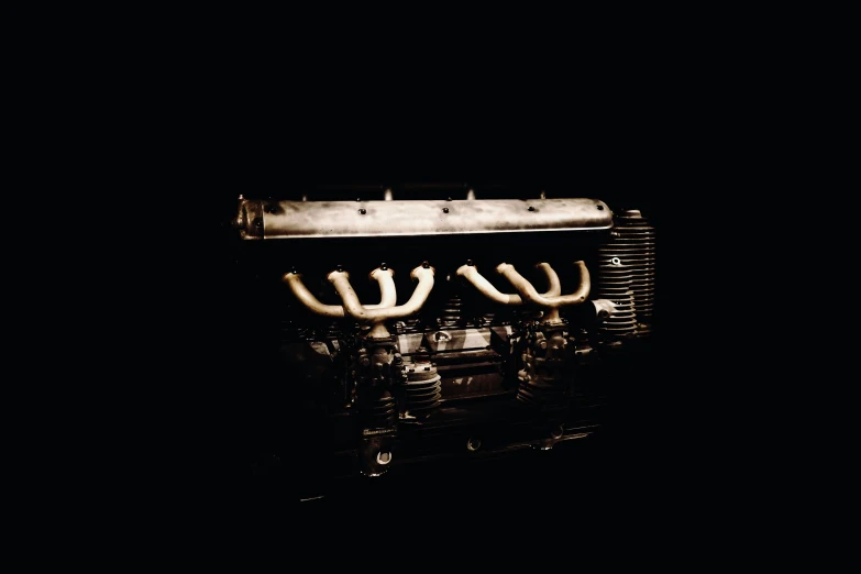 closeup image of engine with wires and harness in darkness