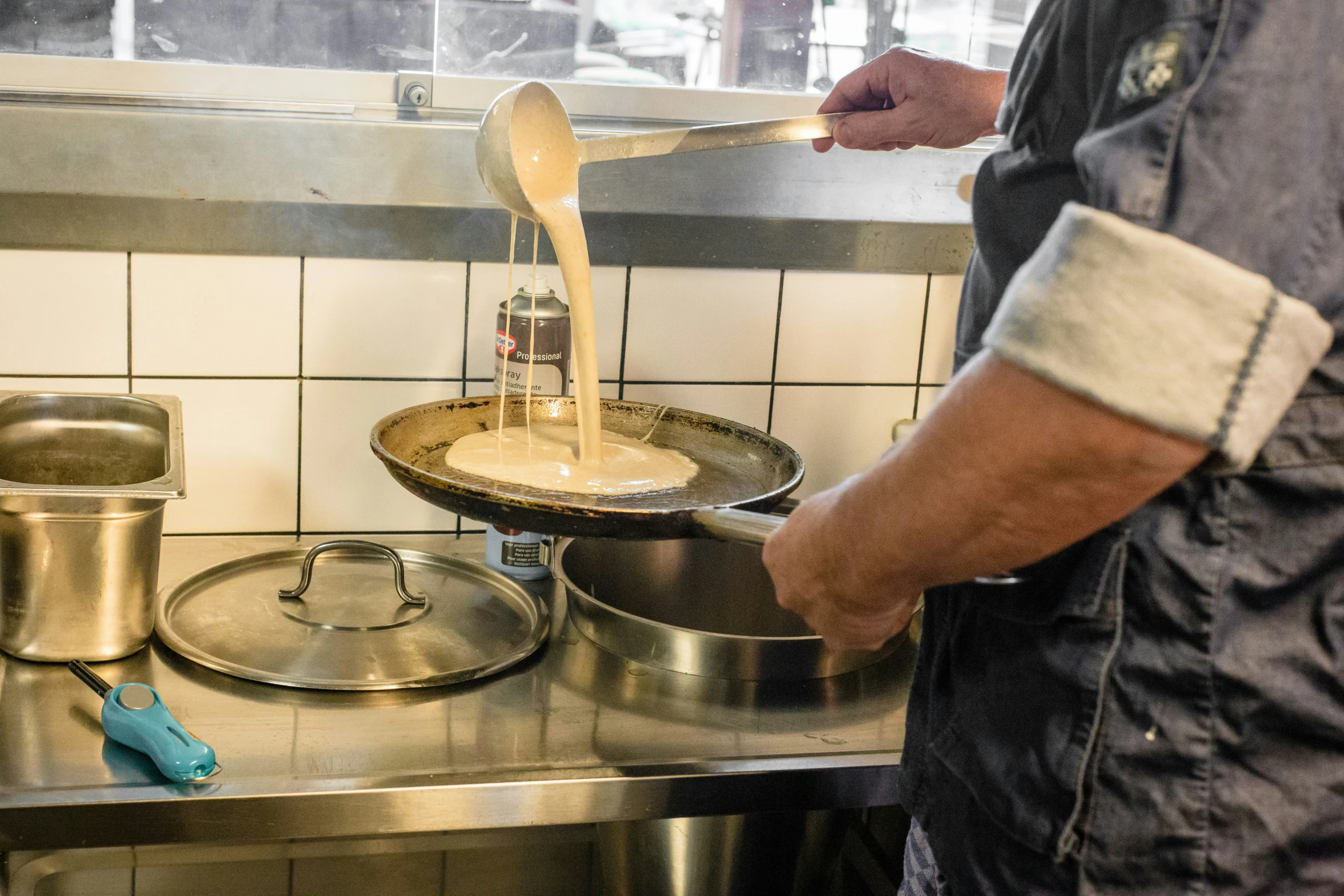 a man stirring ingredients into a bowl on top of the kitchen stove