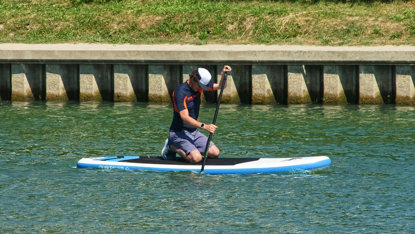 a man is on top of a small surfboard