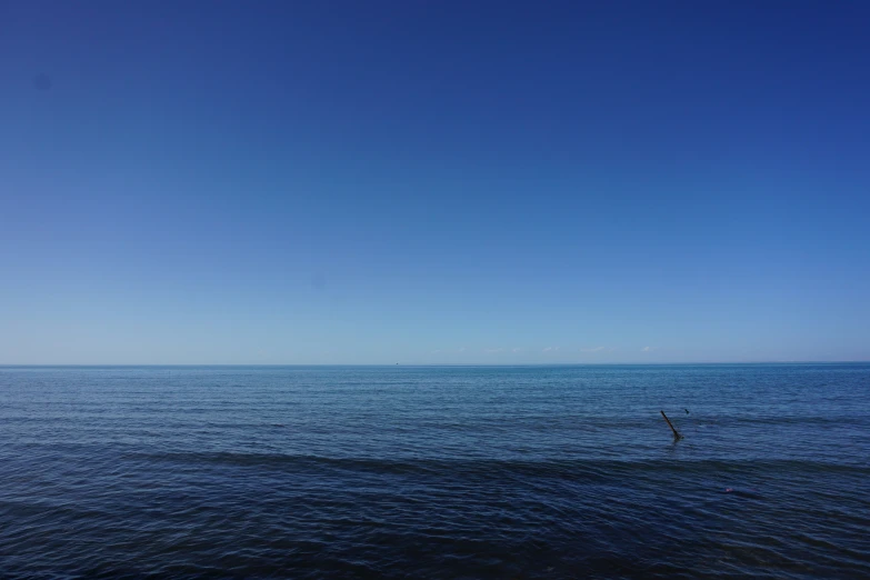 a large body of water under a blue sky