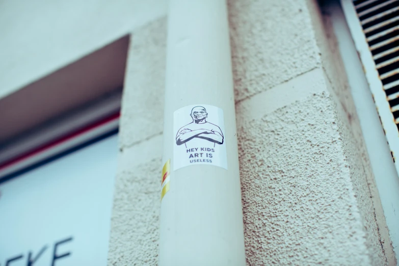 a sticker is stuck on the wall of a building