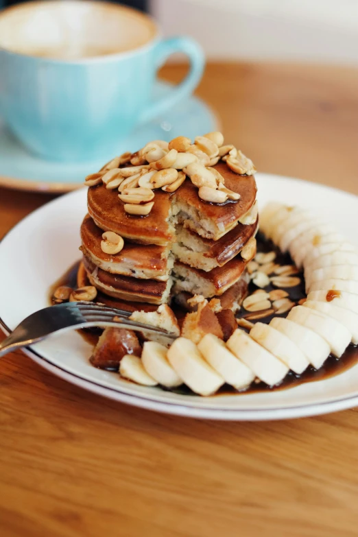 a plate that has some pancakes and bananas on it