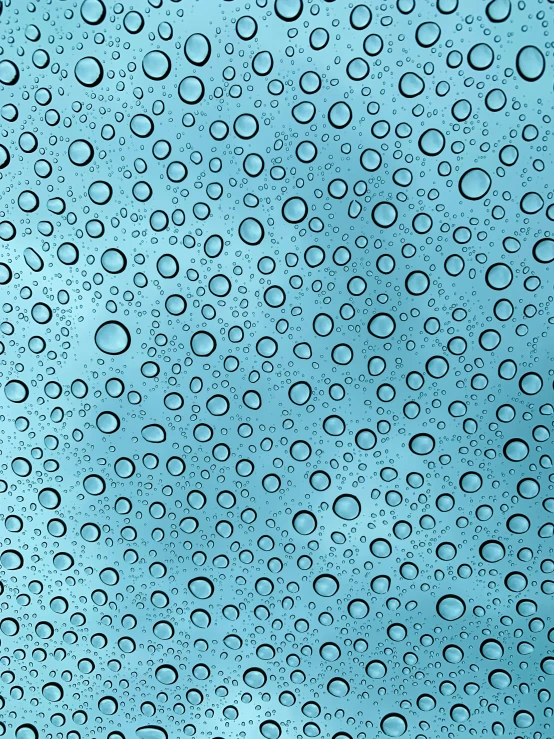 rain drops on the window with a blue sky background