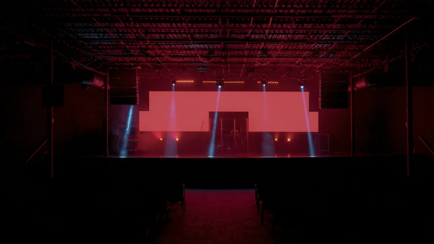 dark image of the stage lights and sound equipment on the stage