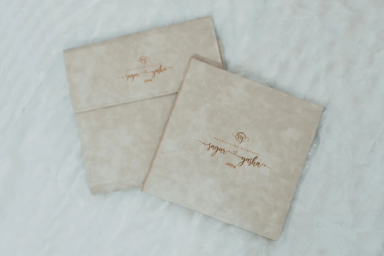 two sheets of brown paper with handwritten name and date on them