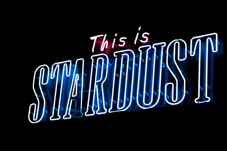 a neon sign with the words, this is stardust