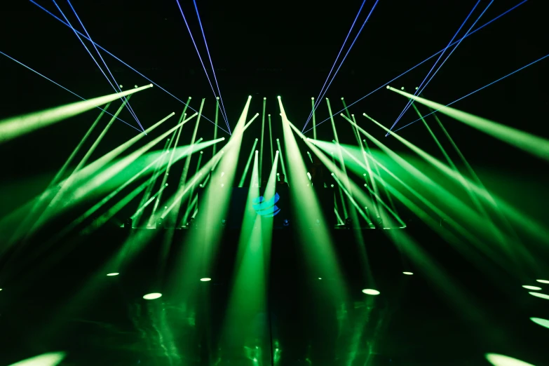 bright green lights in a dark room filled with blue and white rays