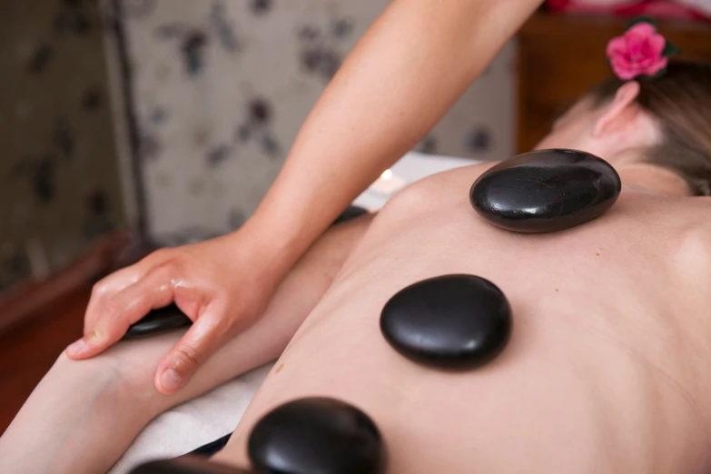 a person getting stone massage in a spa