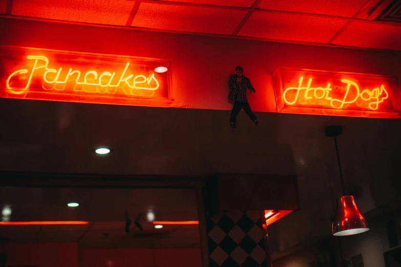 red neon signs in front of a large white building