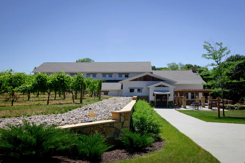 an exterior view of a large home with trees