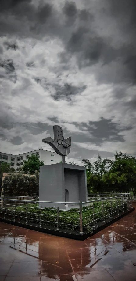 a large gray monument with a bird in it's beak