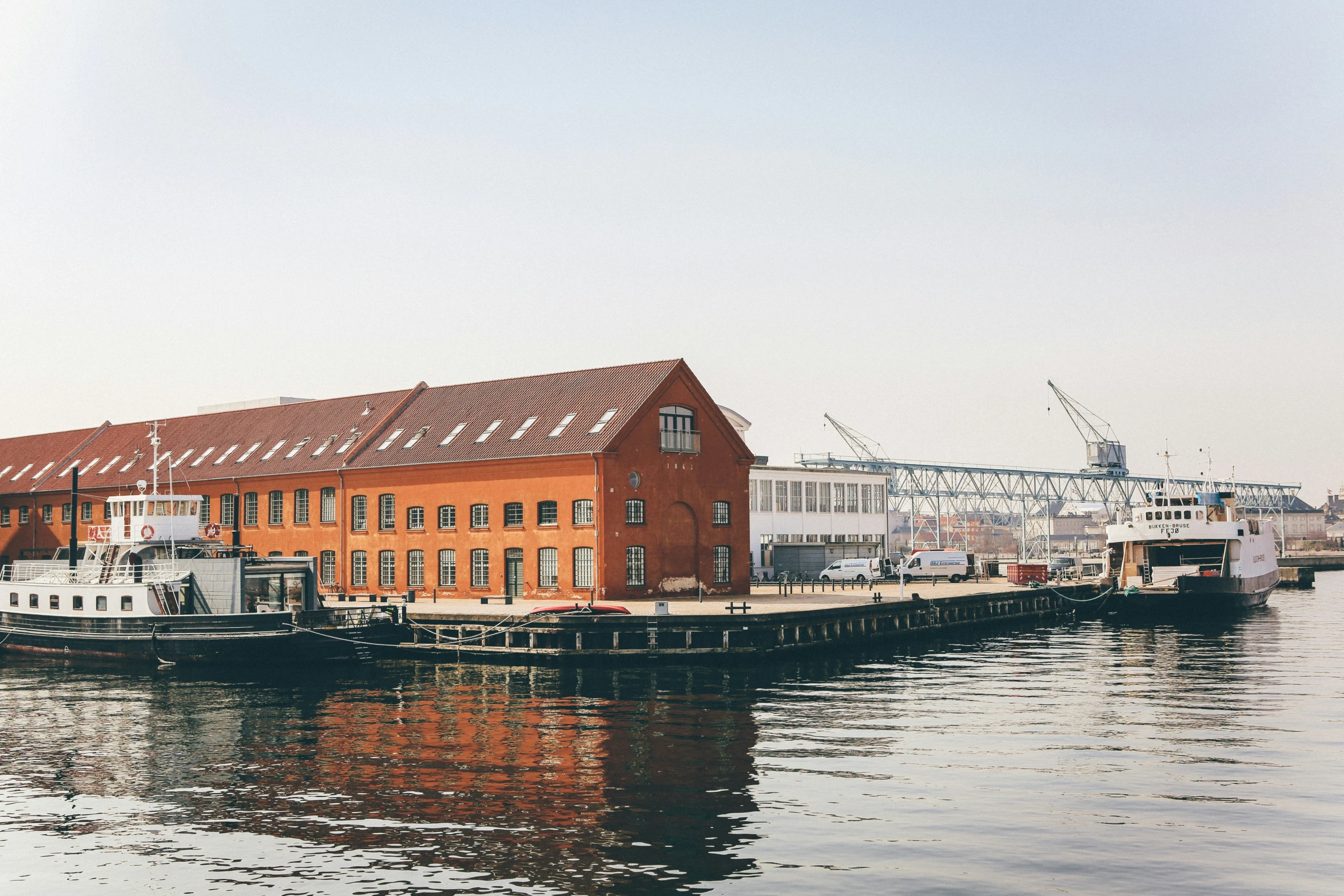 a building is on a body of water with boats around it