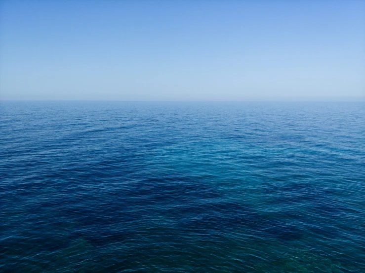 the ocean is mostly calm and clear on this sunny day