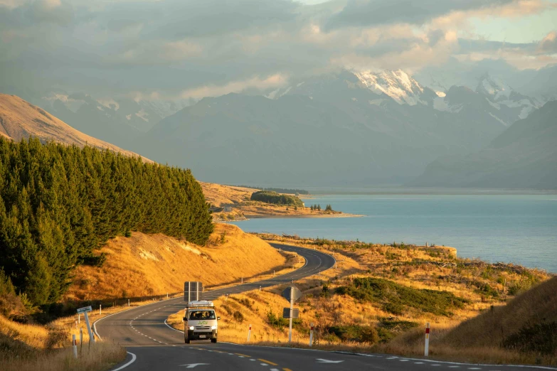 a truck driving along the side of a road