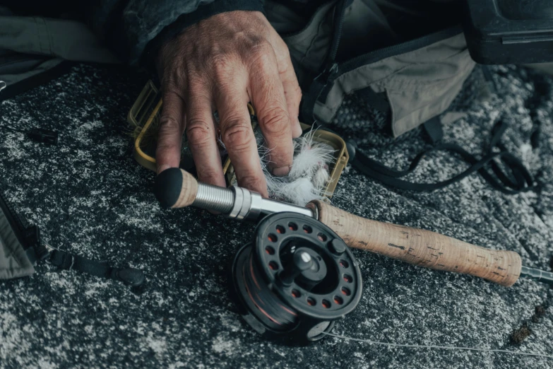 a man is spinning the spinning wheels on his fishing rod