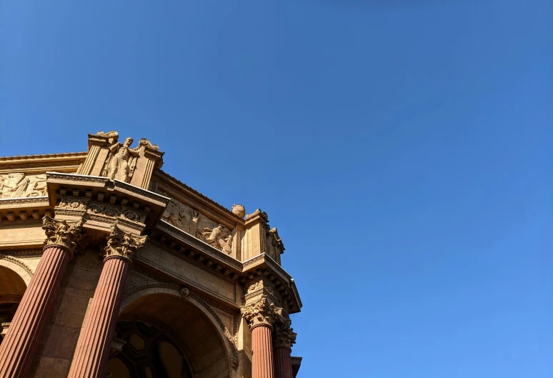 a tall building with ornate pillars in the background