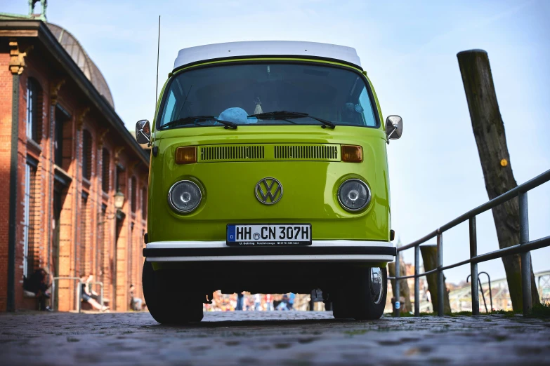 a neon green bus is parked on the side of the road