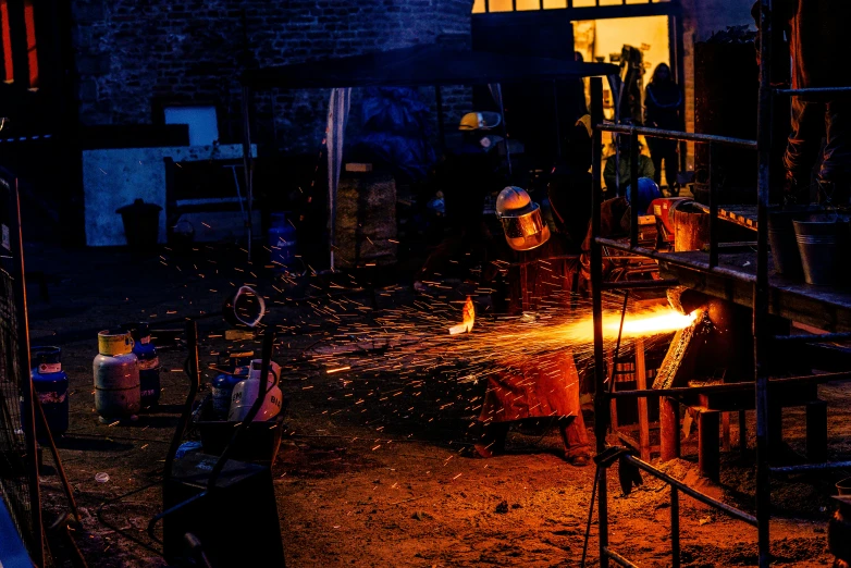 a man is lit in an industrial area by fire