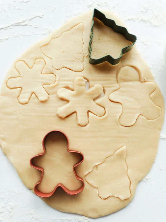 a cookie shaped to look like a christmas tree and other cookies