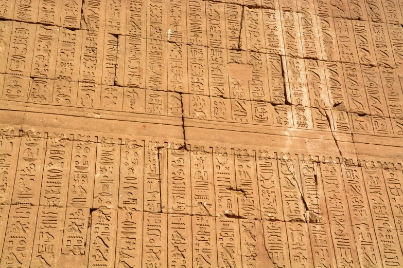 large wall with multiple writings written in the ancient script