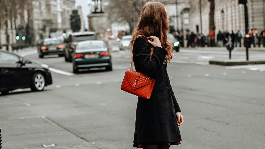 a woman in a black coat on the phone