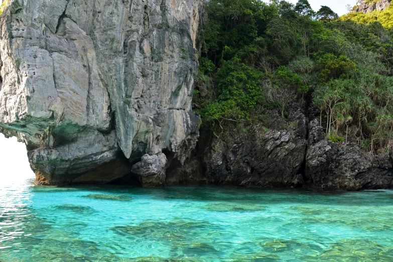 the blue and green water is near two rocks