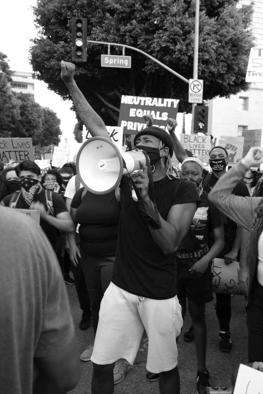 a man holding a megaphone at a protest