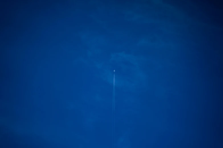 an airplane flying up in the sky on its side