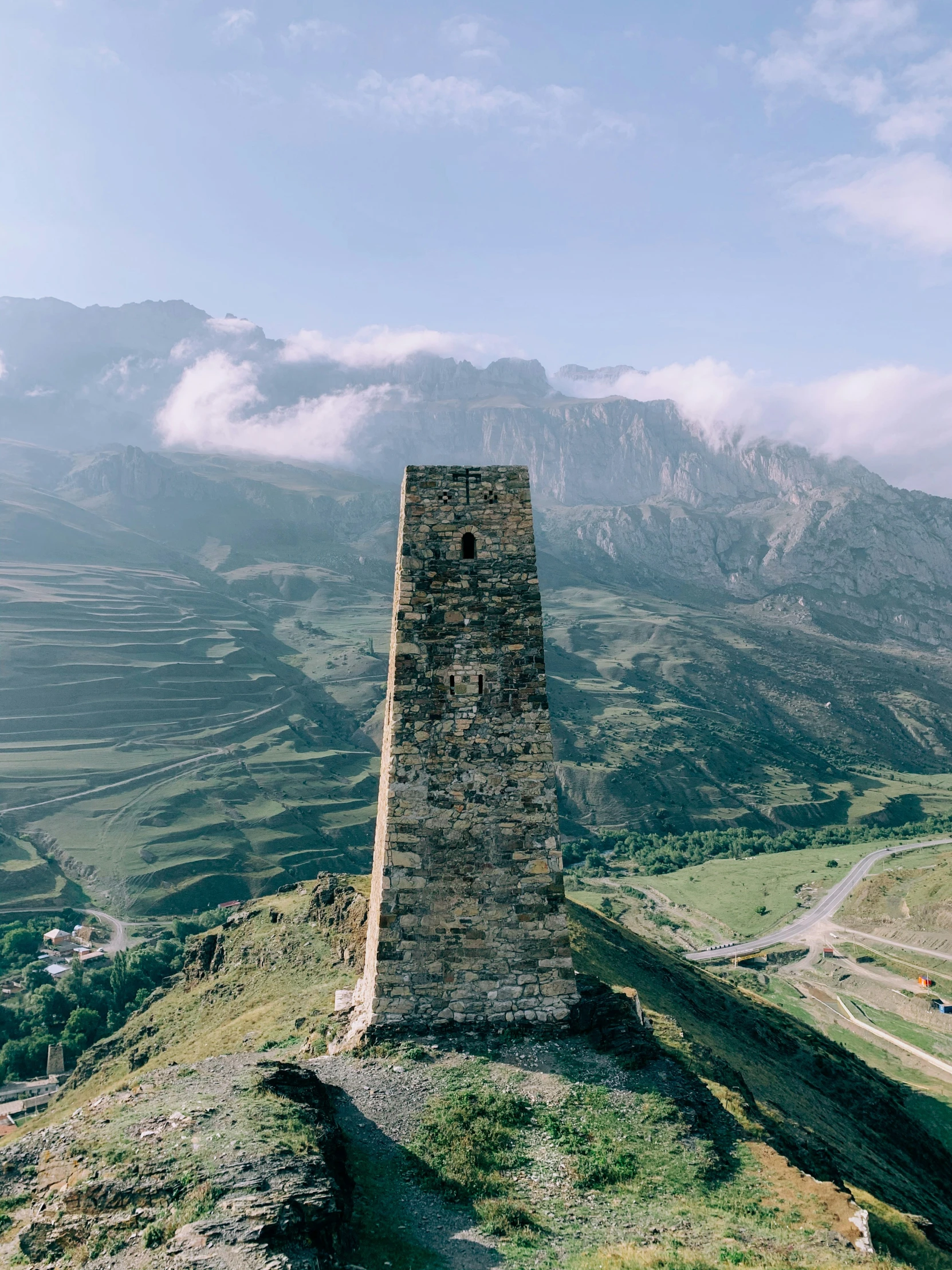 a tall brick structure standing on a hillside