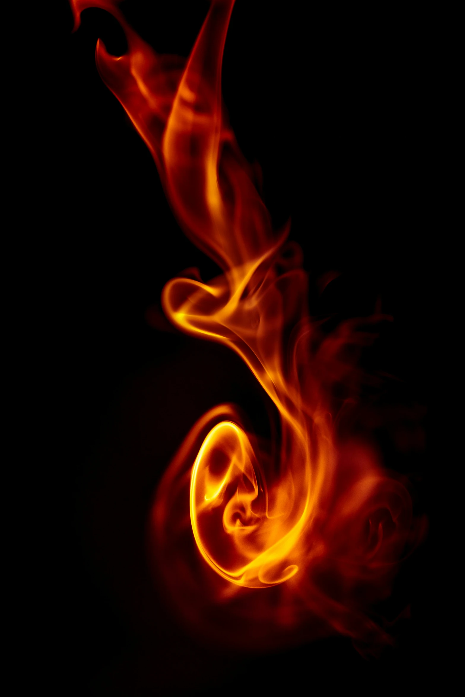 an abstract red and yellow fire swirling over black background