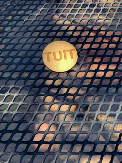 a tut sign is laying on a tile surface