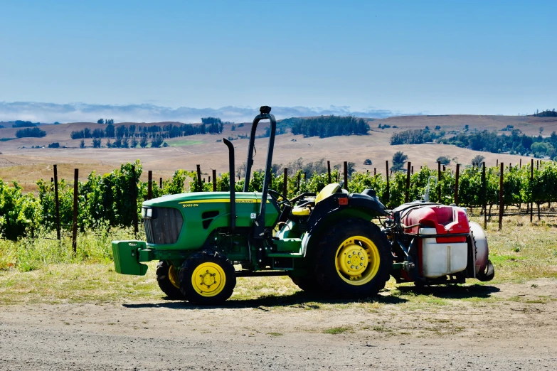 a tractor parked in front of several white containers