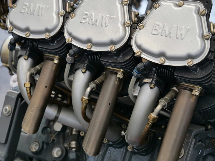 two silver exhaust pipes on the top of a motorcycle engine