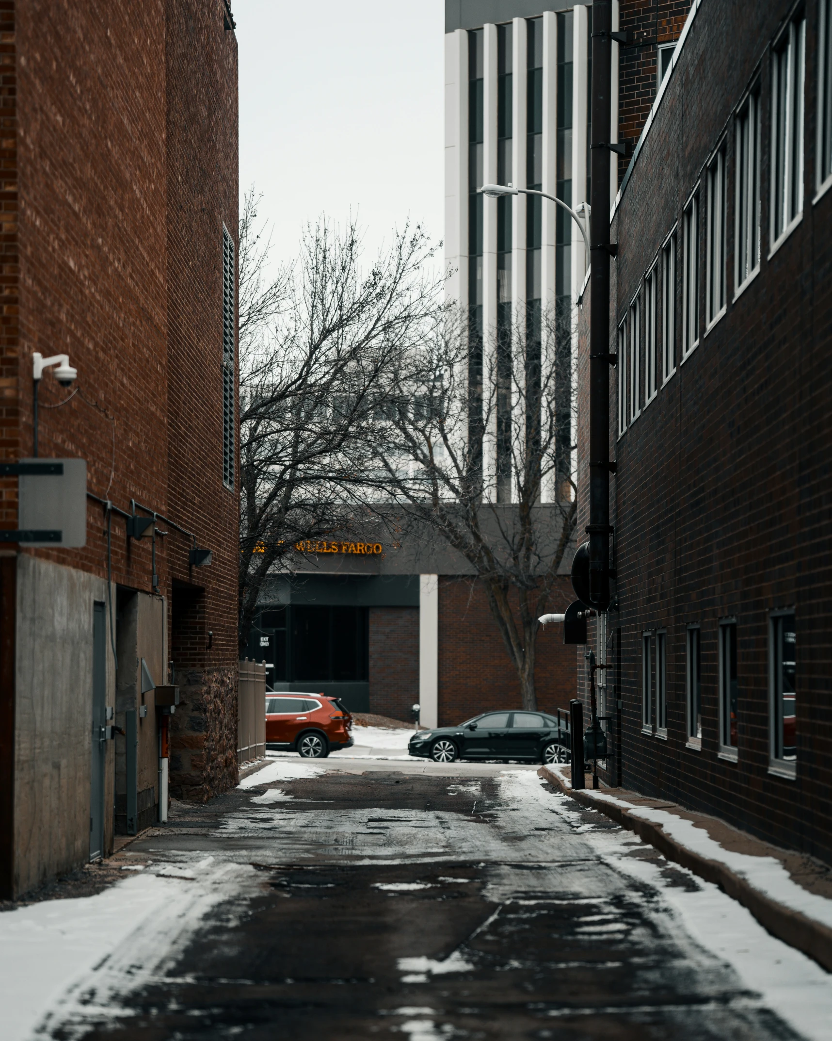 a car parked in the snow next to some buildings