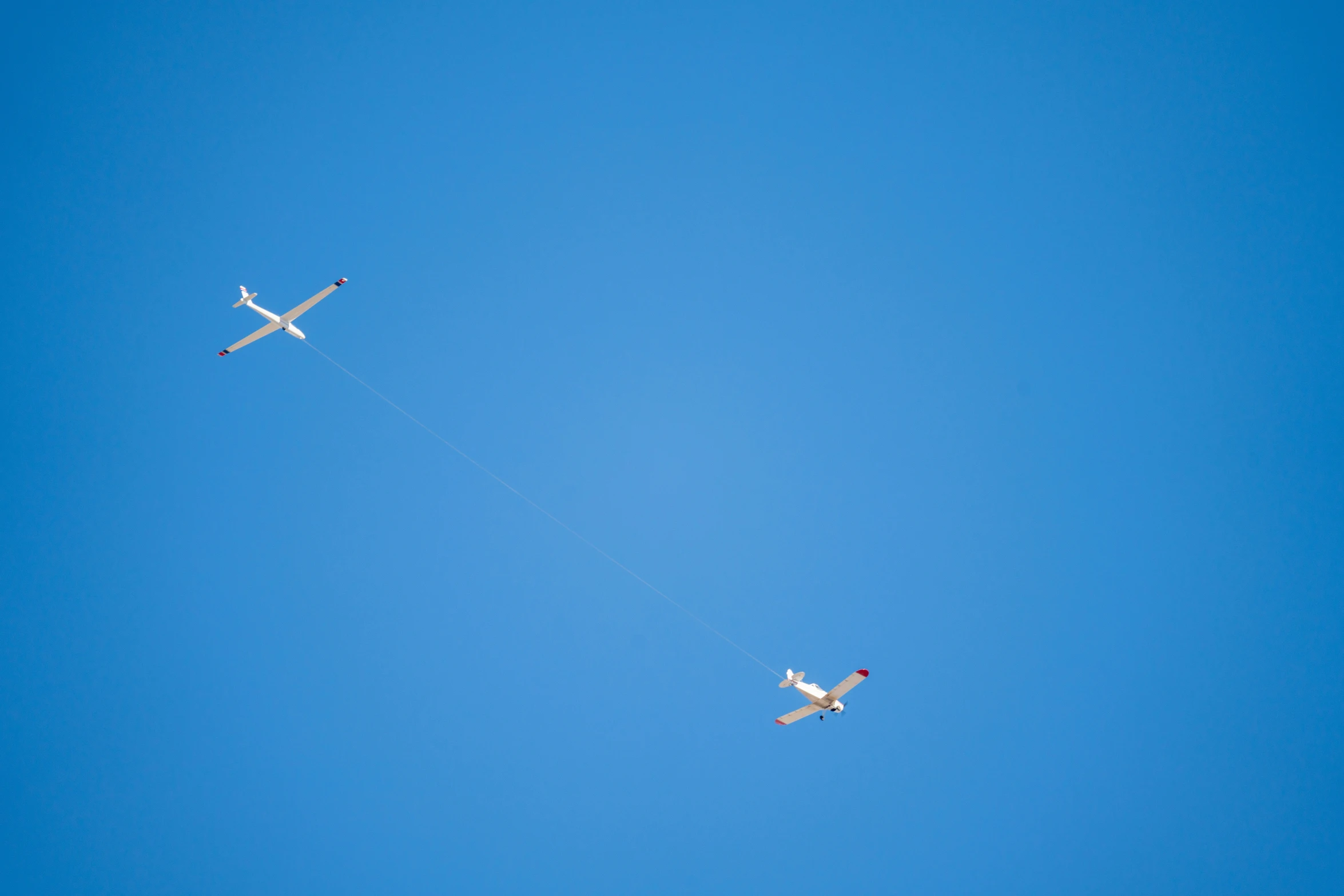 two planes are flying in the blue sky