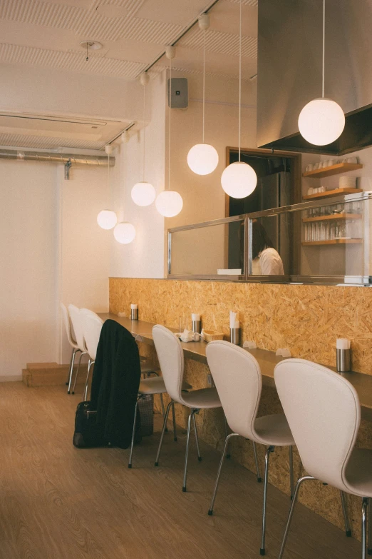 a restaurant with chairs and a counter