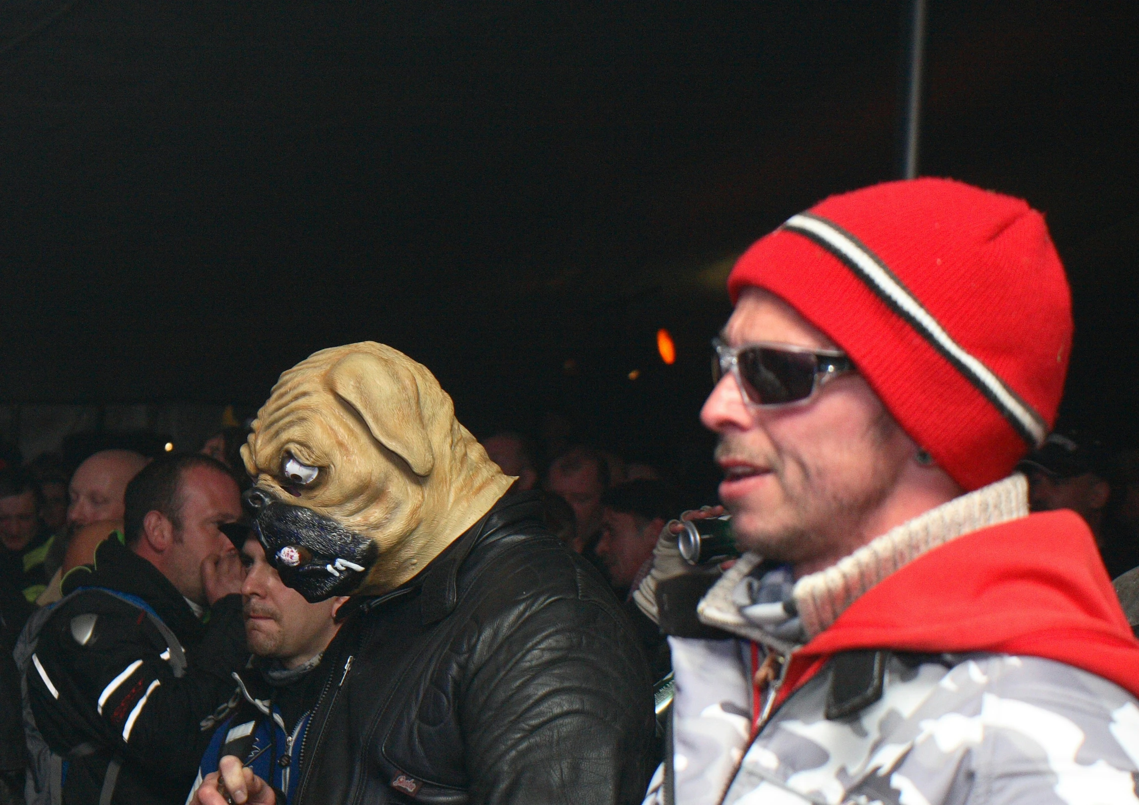 two people with masks and glasses sit on the seats