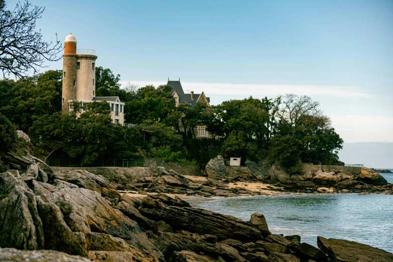 an image of a lighthouse on the ocean shore