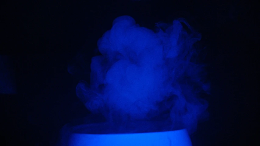 steam from a mist plume is pouring into a white cup