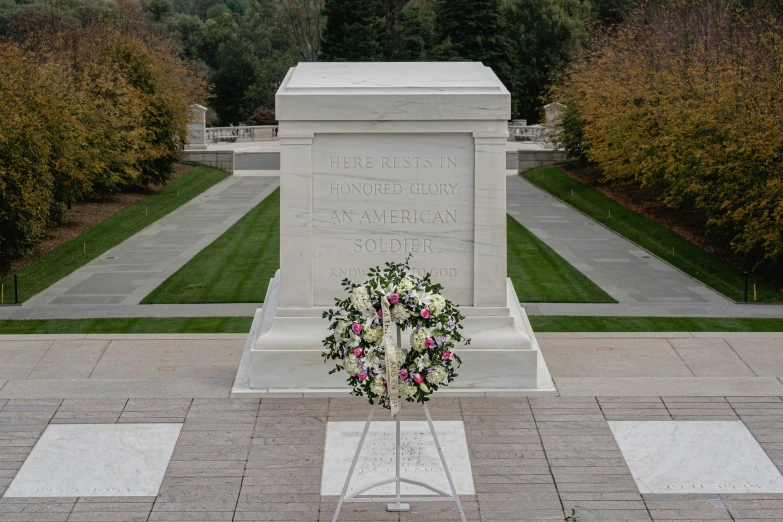 a memorial surrounded by two white crosses and some trees