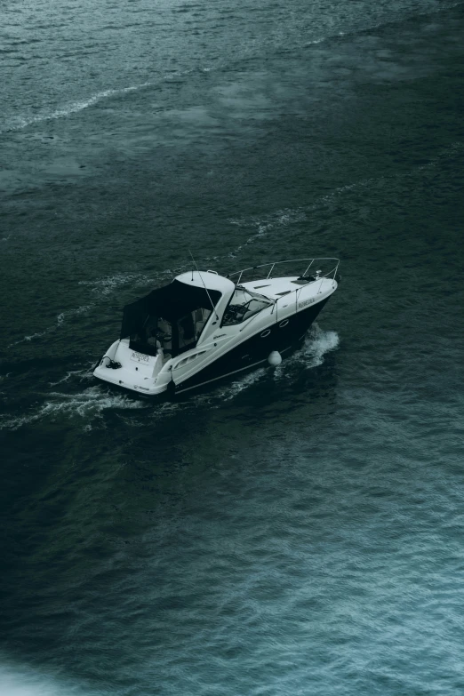 a boat is going through the water on dark day