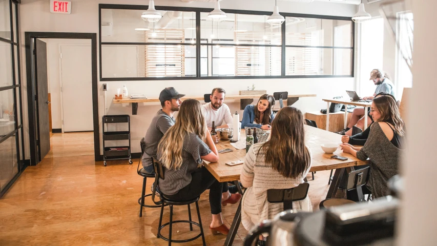 several people sitting at a table in a room