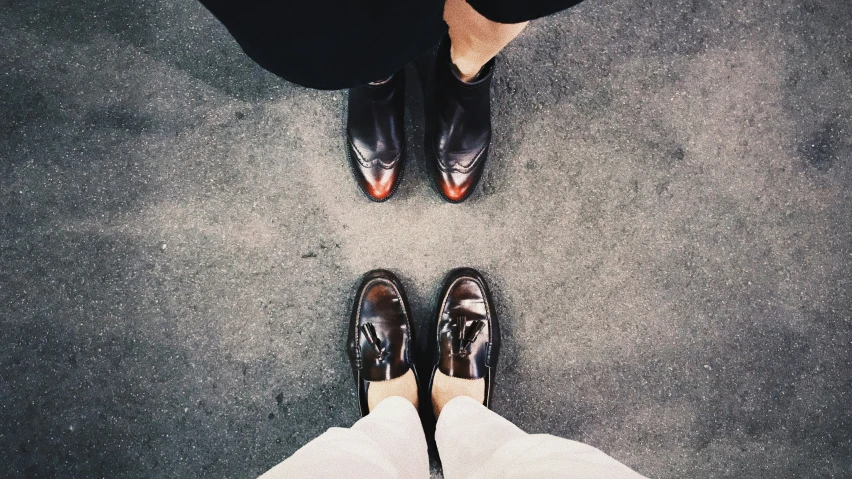 pair of feet wearing dress shoes from above