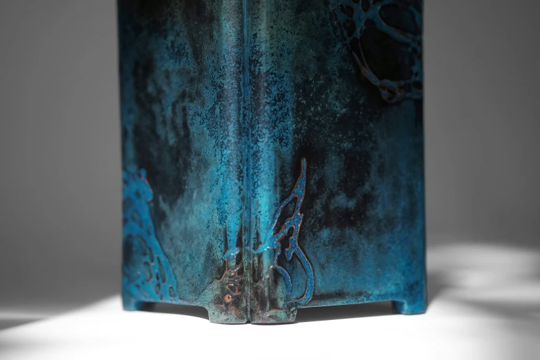 a very colorful vase that has been decorated with black and blue paint