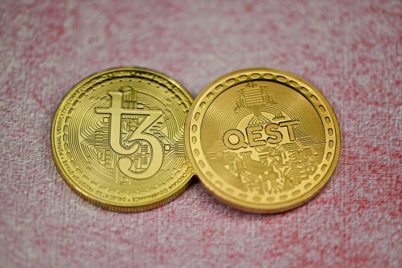 two coins with designs on them laying on the floor