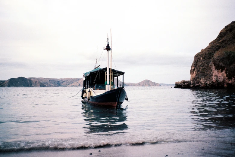 a small boat floating on top of a lake