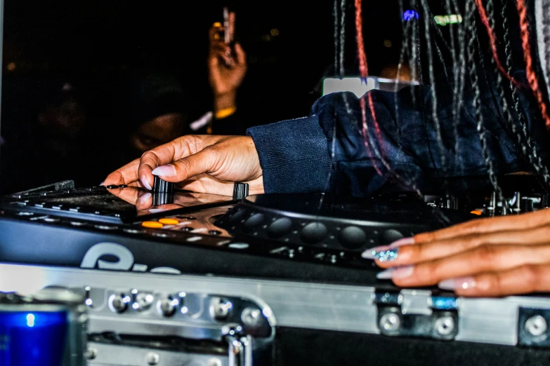 a group of hands are playing music on some equipment