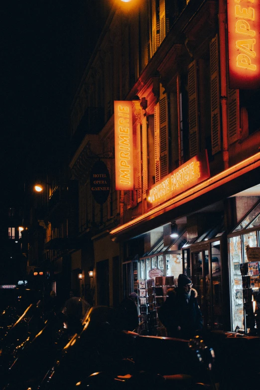 a dark street with several stores and traffic