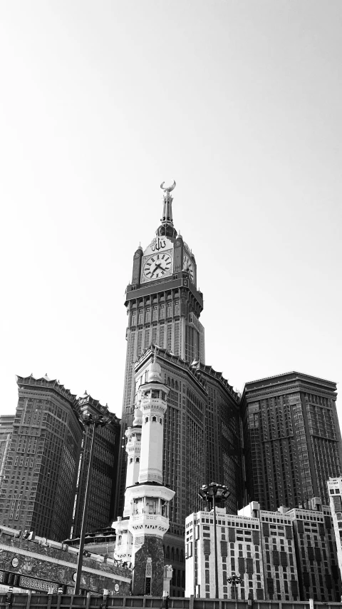 a clock tower with skyscrs and other buildings behind it